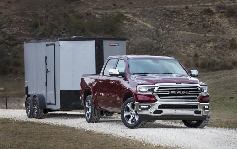 2023 ram 1500 red towing trailer